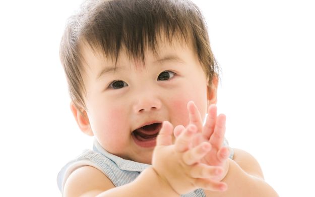 A baby clapping its hands for self assurement